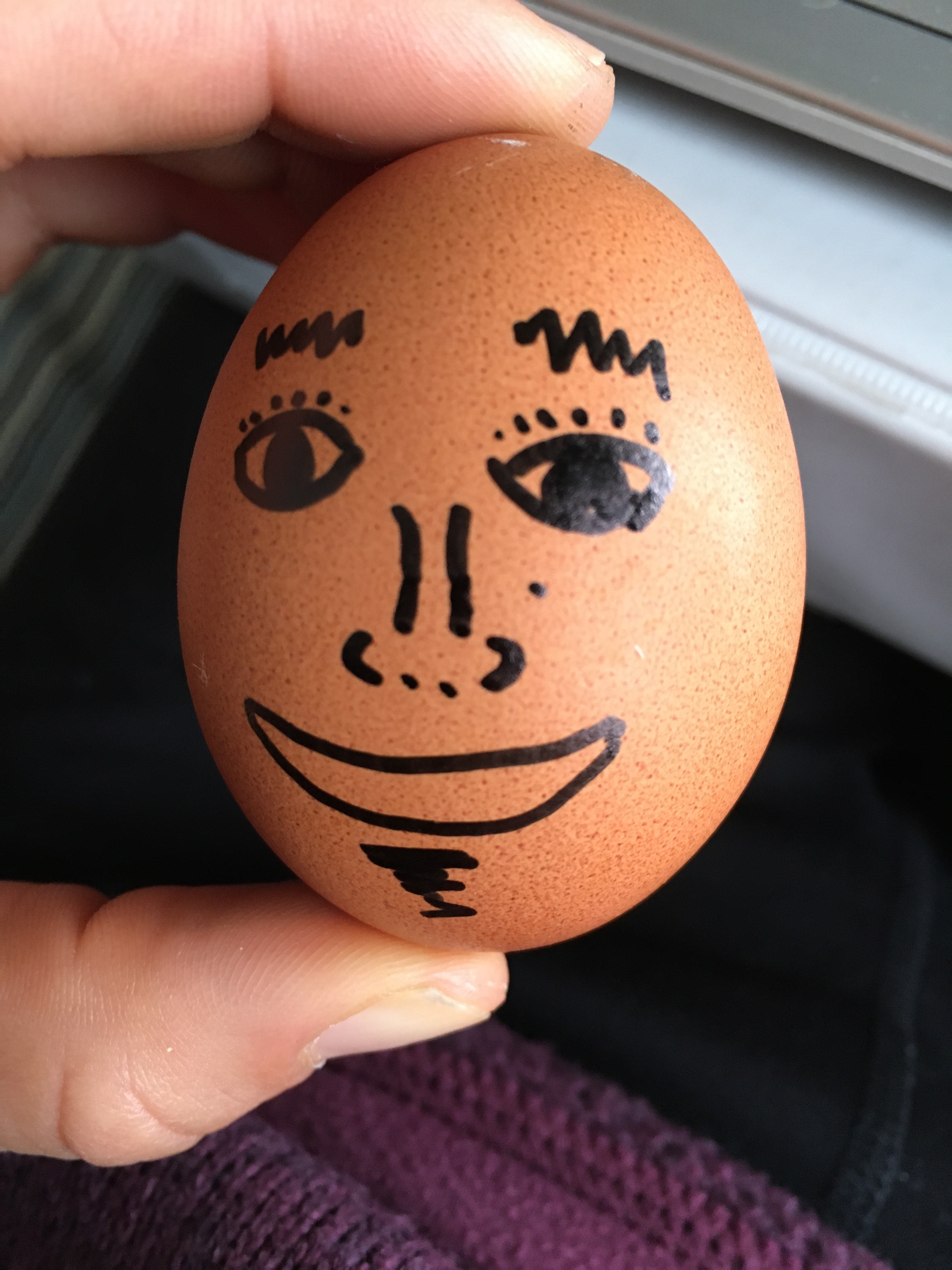 An egg with a face with a goatee drawn on it