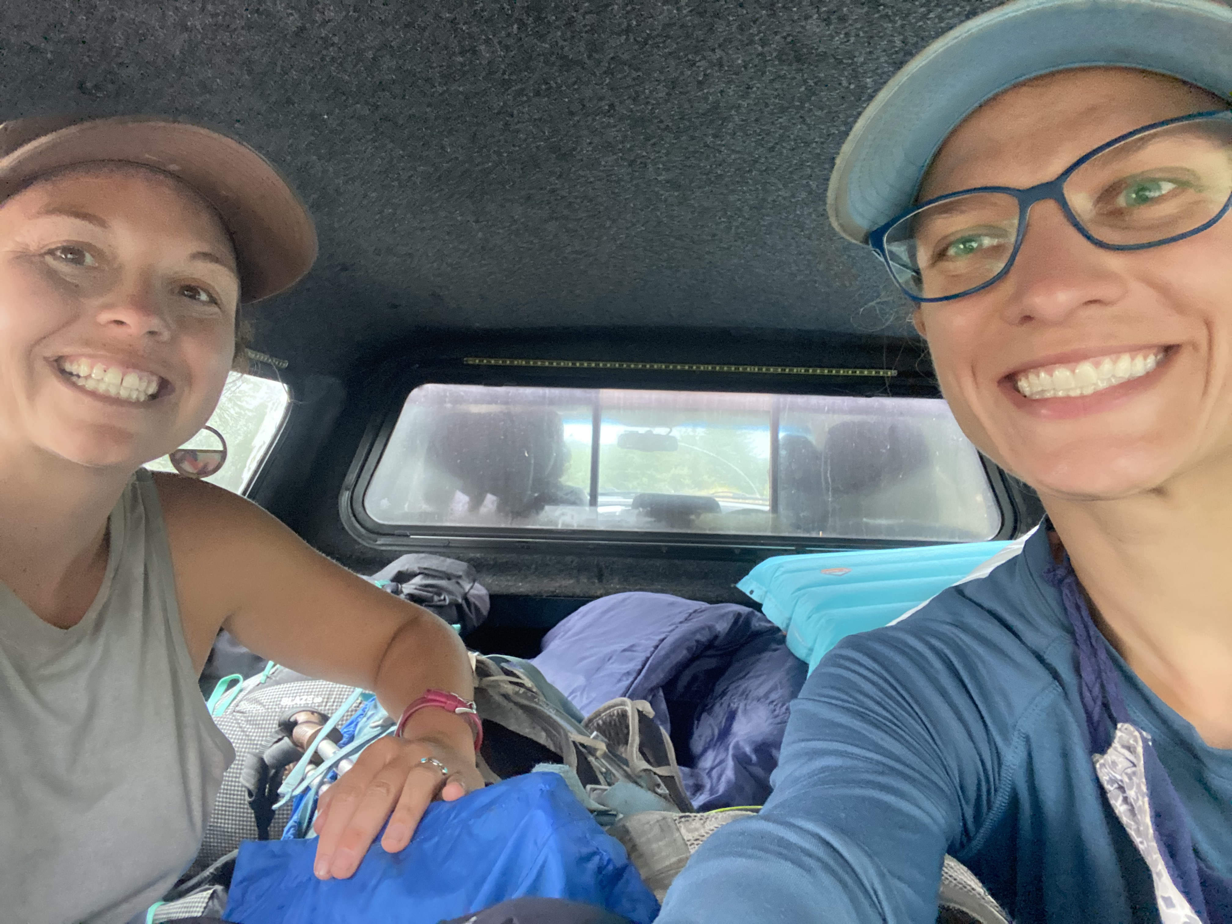Two women in the back of a truck.