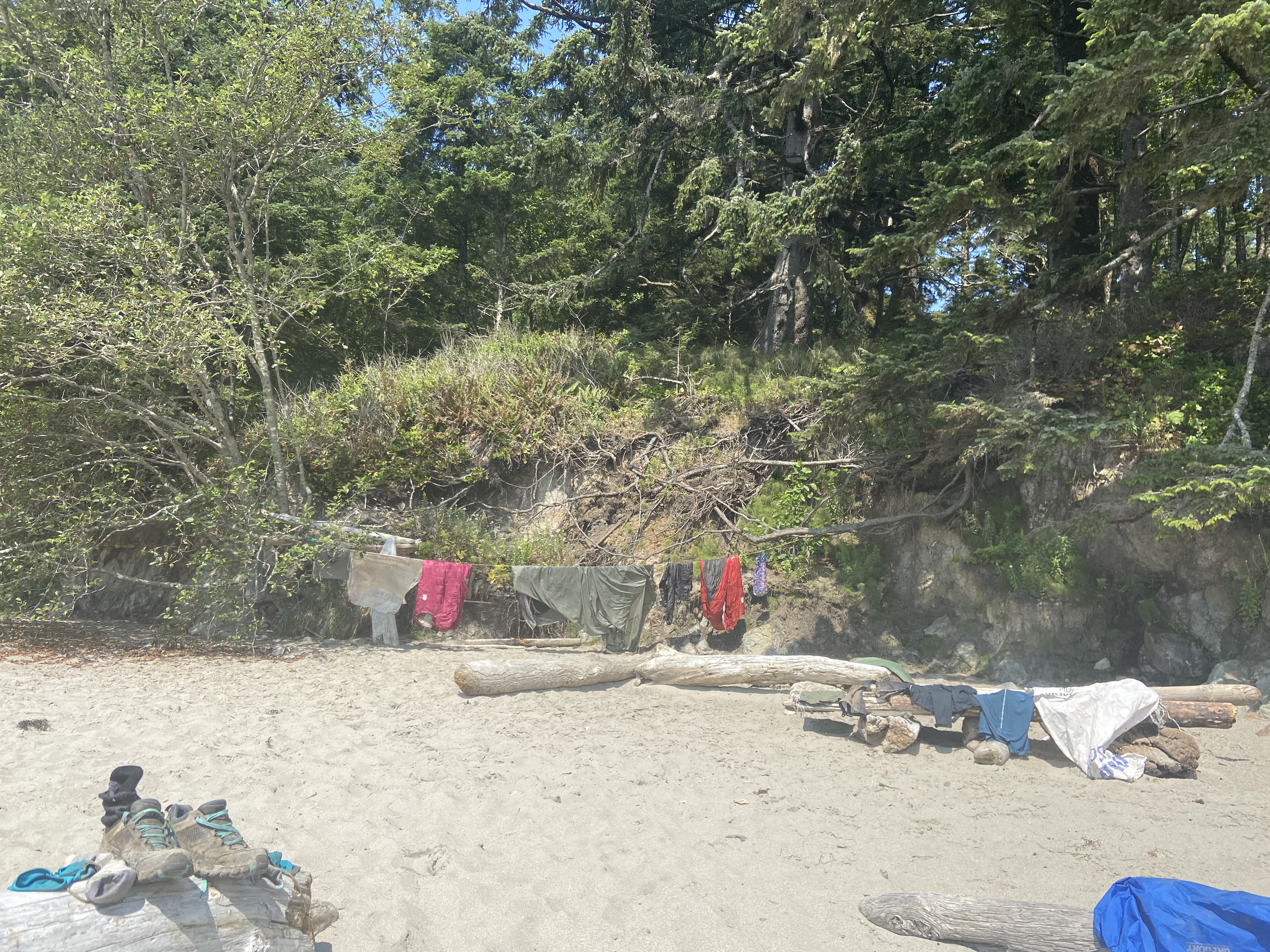 Clothes and gear spread out in the sun to dry.