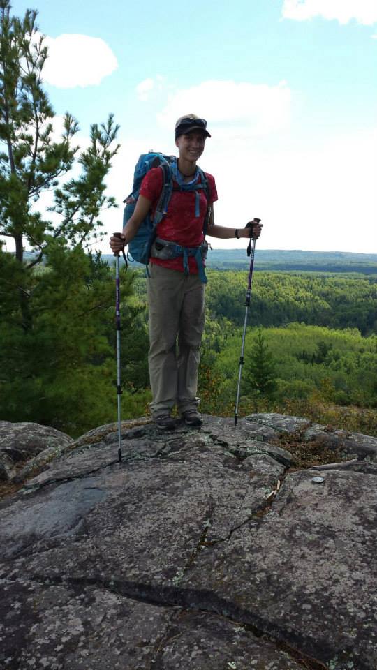 A picture of Anna in front of an overlook of Canada. The northern terminus of the SHT.