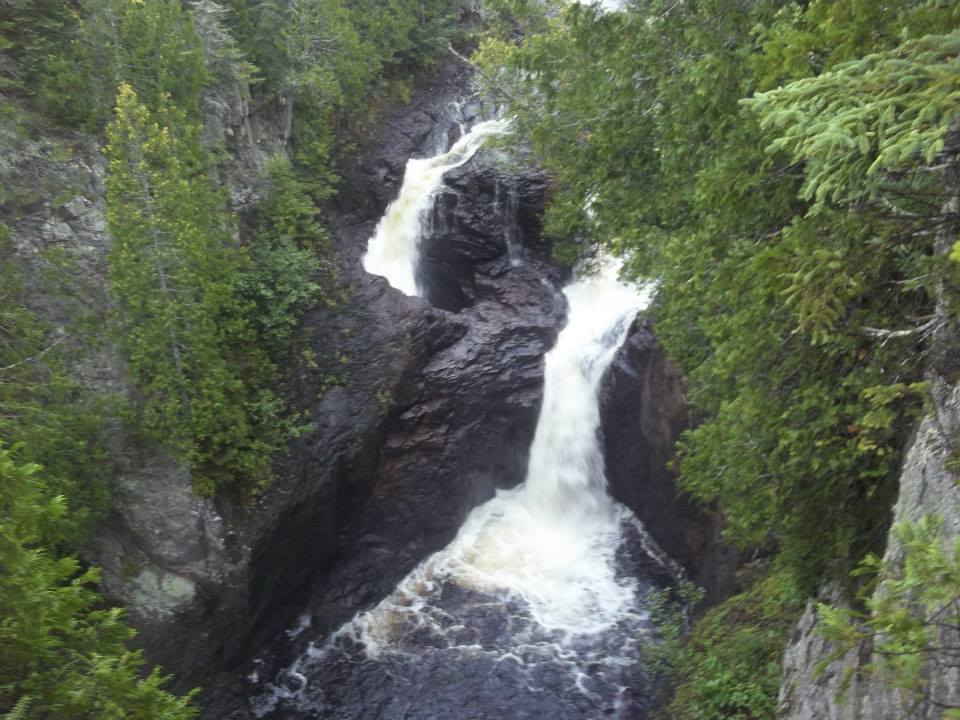 A picture of Devil's Kettle, a pair of waterfalls where one drops into a hole and scientists aren't positive where all the water ends up.