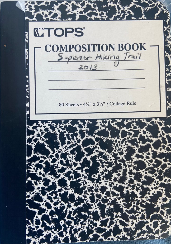 The cover of a small notebook with title "Superior Hiking Trail 2013."
