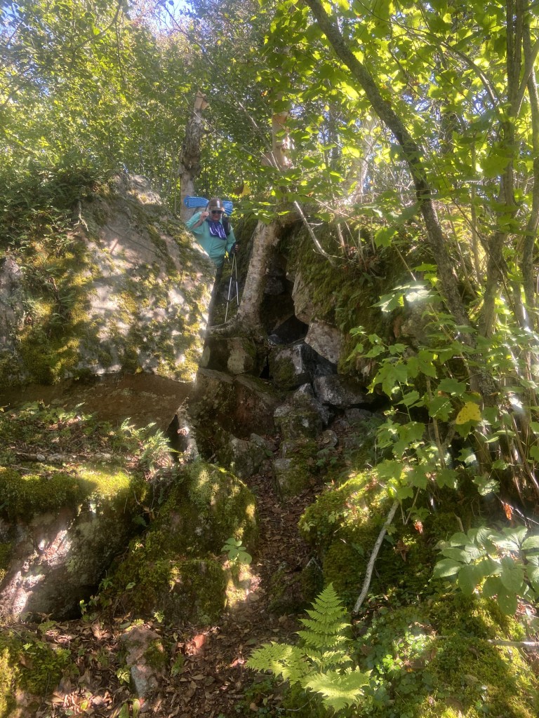 A backpacker making her way down a steep and rocky section of trail.