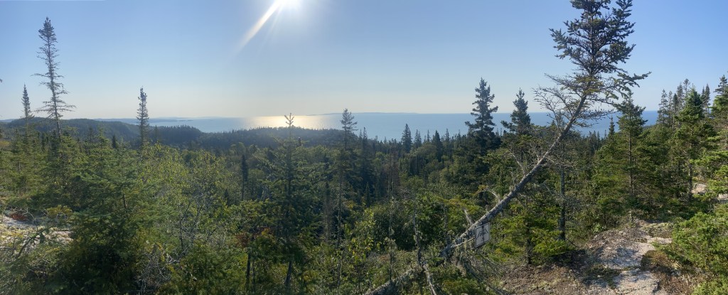 A sunny view of lake superior from the top of a rocky knob.